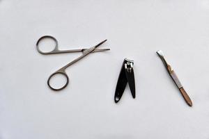 Manicure accessories scissors and file on a white background photo