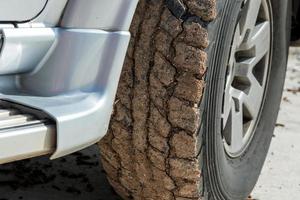 Wheels closeup in dry mud, off-road photo