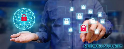 Cyber security network concept, Young asian man holding global network security and pressing lock icon with virtual screen. photo