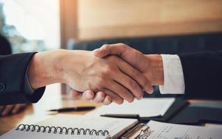 Department heads manager are shaking hands and accept to new employee in office room. photo
