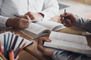 Teenager studying at desk and doing homeworks photo