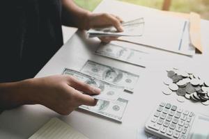 Asian men are holding banknotes in cash and placed on the table with the idea of saving money. photo