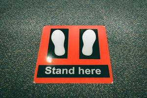 Stand here symbol in security checkpoint at airport. photo