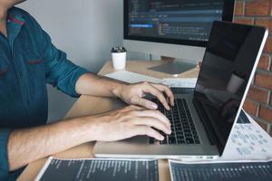 Asian man working code program developer computer web development working design software on desk in office. photo