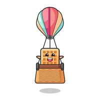 waffle mascot riding a hot air balloon vector