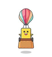 yellow card mascot riding a hot air balloon vector