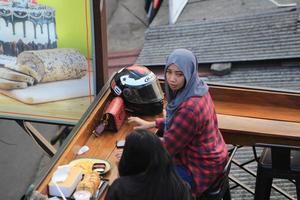 Jakarta, Indonesia - February 26, 2021. Two more women are discussing in a cafe photo