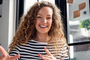 Close up shot of happy smiling Caucasian woman talking while making video call conference at home photo