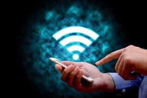 Internet technology and networking concept, Businessman holding smart phone using wifi. photo