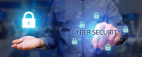 Business man poiting and pressing on button cyber security button on virtual screens with holding lock icon on hand. photo