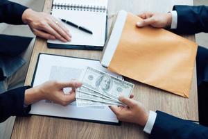 Entrepreneurs are receiving money that is a bribe of their partners with both of whom are corrupt in the company room. photo