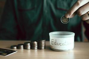 los hombres sostienen monedas que caen en la caja de dinero con el concepto de ahorro. foto