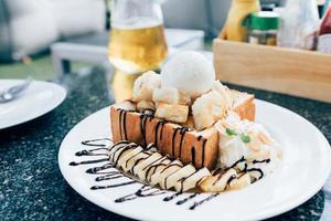 Honey toast with banana and vanilla ice-cream. photo