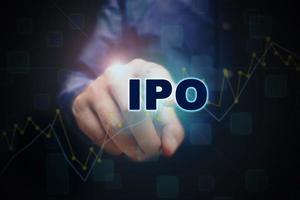 Close up finger pointing into the ipo text with initial public offering concept. photo