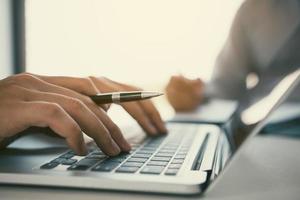 Managers are using fingers to typing personal information of employees who apply for jobs on the computer. photo