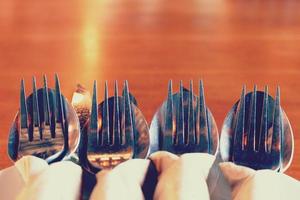 Close up fork and knife on dish in restaurant with copy space. photo