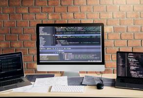 Computer of the software developer on the desk in the room office. photo