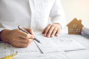 Architects working with blueprints and discussing project together at the meeting in the office. photo