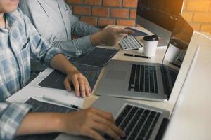 Professional development programmer cooperating meeting programming website working a software in office room. photo