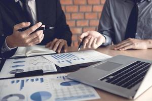 Businessman looking graph and summary report on document finance budget paper with analysis cost data result. photo