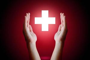 Healthcare concept, Woman hand holding and protect medical symbol on red background. photo