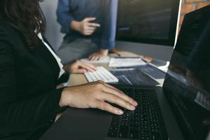 Professional development programmer cooperating meeting programming website working a software in office room. photo
