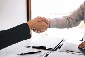 Manager and employee interview concept with handshake after talking about contract signing. photo