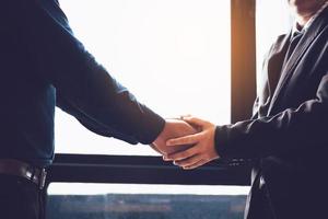 Business people compassionately holding hands at office room. photo