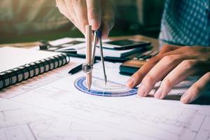 Architect engineer man calculate building area with equipment on desk at home office. photo