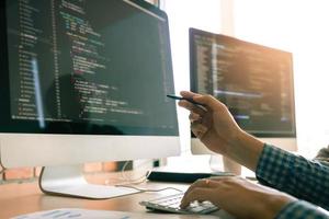 Developing programming working in a software engineers code tech applications on desk in office room. photo