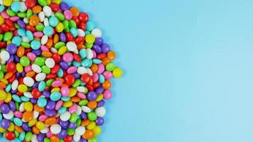 colorful sweet candy balls on blue pastel background. trendy color for background with copy space photo