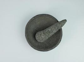 Indonesian traditional mortar and pestle isolated on a white background photo