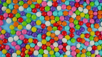 colorful sweet candy balls on blue pastel background. trendy color for wallpaper or background photo