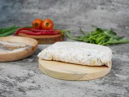 raw tempeh on a wooden cutting board photo