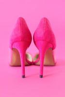 stylish pink high heels shoes on pink background. photo