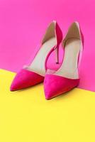 stylish pink high heels shoes on yellow and pink background. Shoes, fashion, style, shopping, sale concept photo