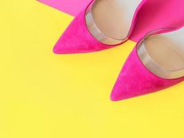 stylish pink high heels shoes on yellow and pink background. Shoes, fashion, style, shopping, sale concept photo