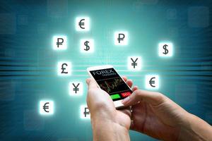 Forex concept, Businessman holding smart phone and currency icon. photo