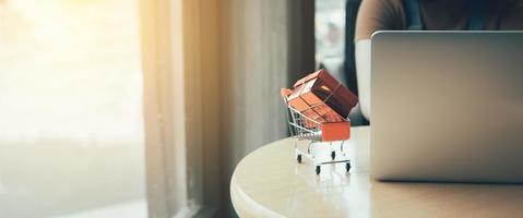 Shopping online concept with woman using laptop in cafe. photo