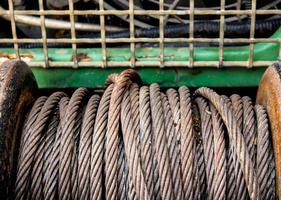 Old sling cable of electric winch in front of 4wd car photo