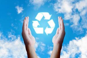 Asian young hand holding recycle  icon and nature clouds and sky background. photo