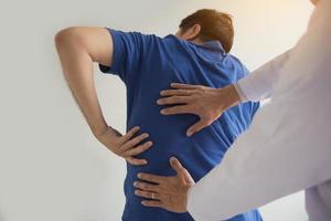 Patient is pointing to the point where the muscle pain is provided to the physical therapist to check. photo