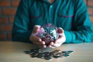 Men carrying holding a piggy bank with a collection concept. photo