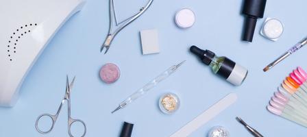 Tools and materials for manicure flat lay with copy space in banner format. Top view manicure background photo