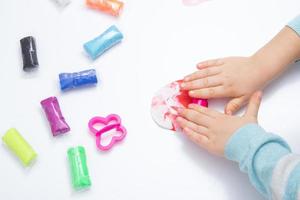 Childrens hands play dough for children's creativity. Board game for the development of fine motor skills photo