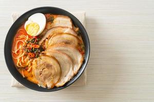 Ramen Noodles Spicy Tomyum Soup with Roast Pork photo