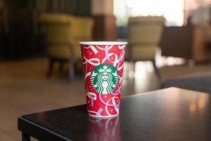 BANGKOK, THAILAND - Nov 24, 2021- Starbucks hot beverage coffee with Christmas theme on the table. photo