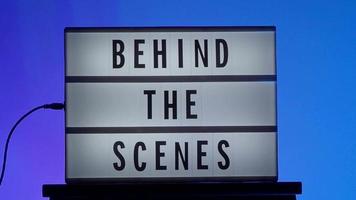 Behind the scene letters on cinema light box. Black text on white LED lightbox video