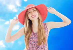 young pretty blonde woman wearing summer hat and dress isolated on white background preparing to vacations photo