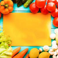 Different vegetables on kitchen table with recipe list and copy space. Top view photo